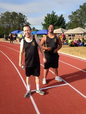 two males at the end of a track and field track celebrating